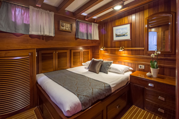 Double cabin on a gulet, wooden panels, comfortable berth 